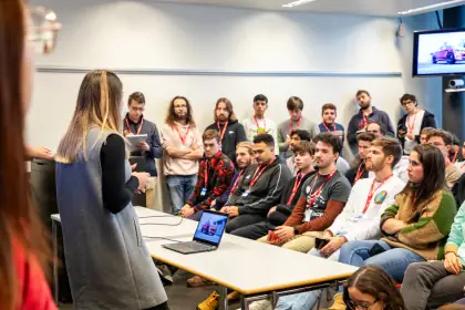 A speaker briefing seated participants at LauzHack